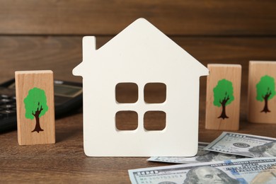 Photo of Mortgage concept. Composition with house model on wooden table