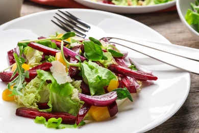 Photo of Delicious salad with beet on plate, closeup