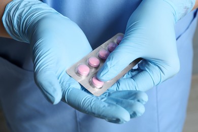 Photo of Doctor taking pill out from blister pack, closeup