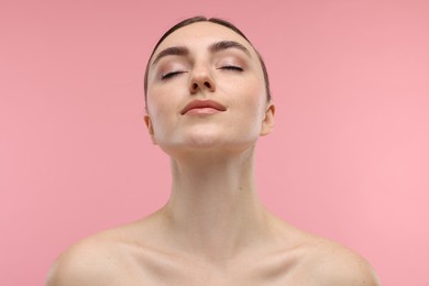 Portrait of beautiful woman on pink background