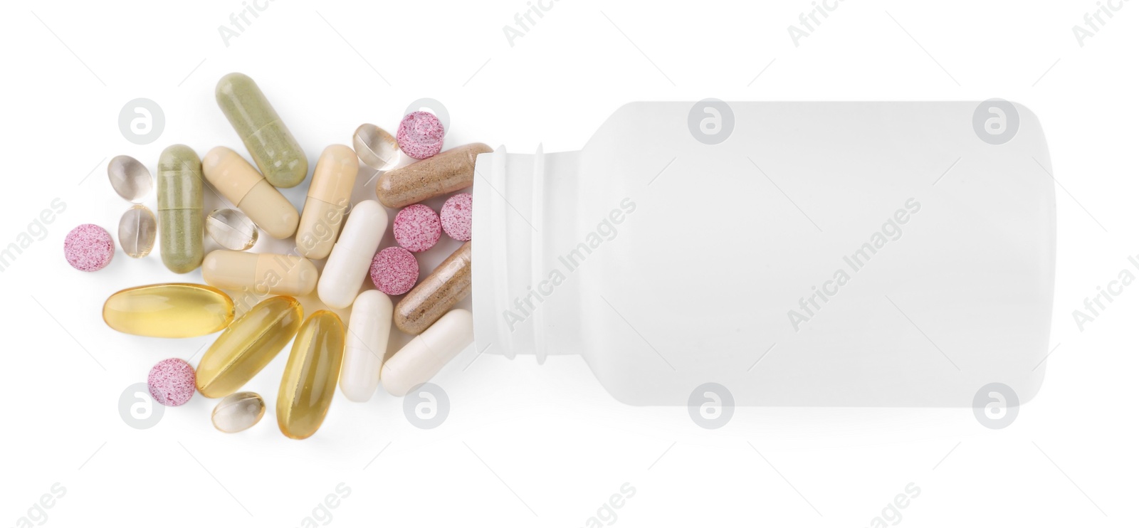 Photo of Bottle and different vitamin pills isolated on white, top view