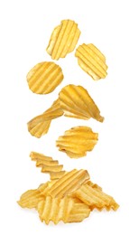 Ridged crispy potato chips falling into heap on white background