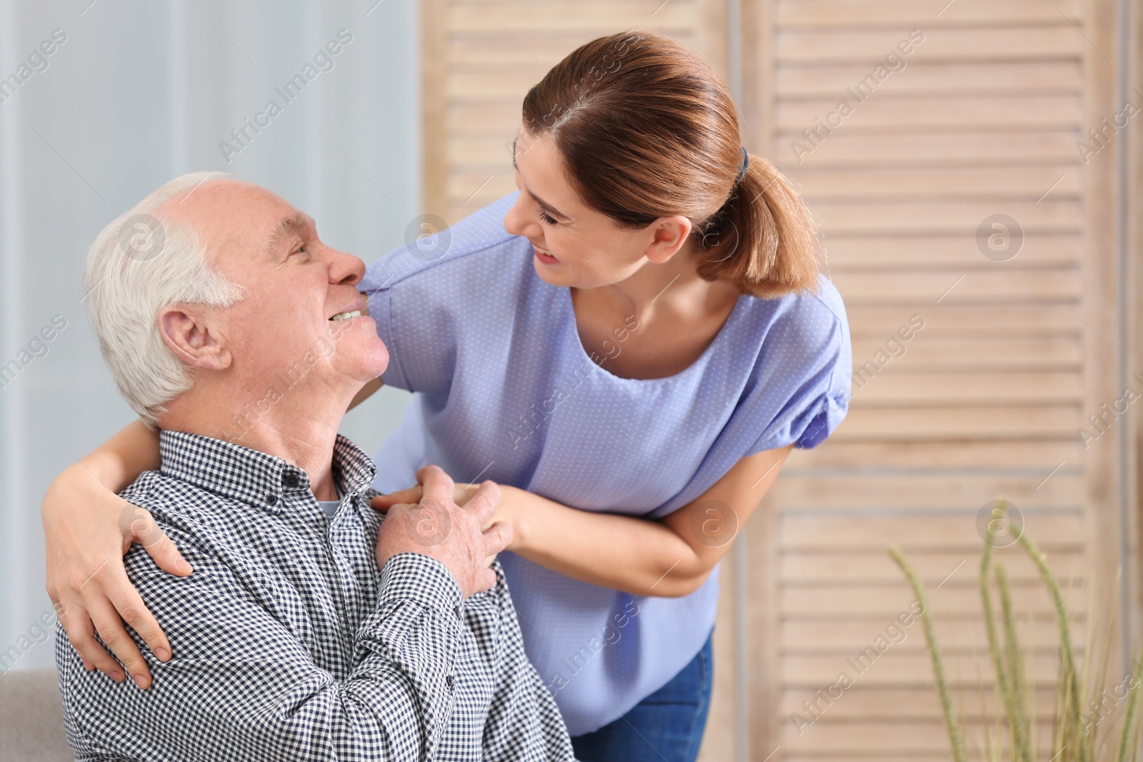 Photo of Elderly man with female caregiver at home