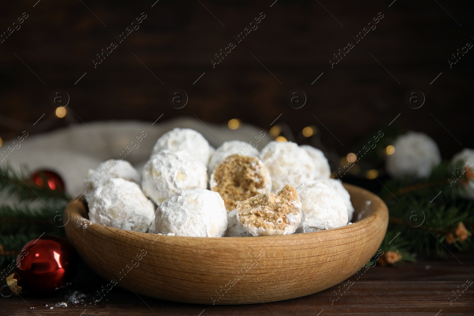 Photo of Tasty snowball cookies in wooden bowl. Christmas treat