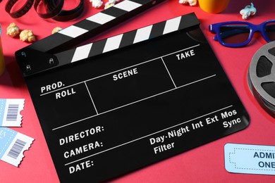 Photo of Flat lay composition with clapperboard and 3D glasses on red background