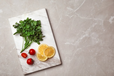 Flat lay composition with fresh parsley, cherry tomatoes and lemon on grey background