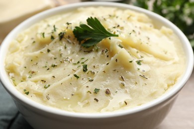 Photo of Bowl of delicious mashed potato with parsley, closeup