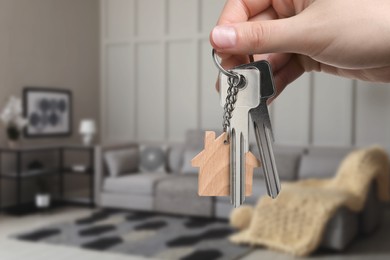 Image of Woman holding house keys in room, closeup