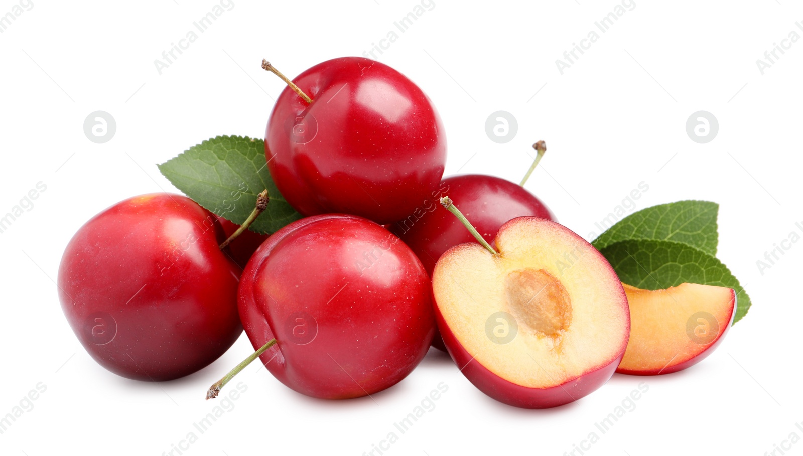 Photo of Cut and whole cherry plums with leaves on white background