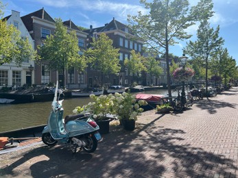 Photo of Leiden, Netherlands - August 03, 2022: View of city street with buildings along canal