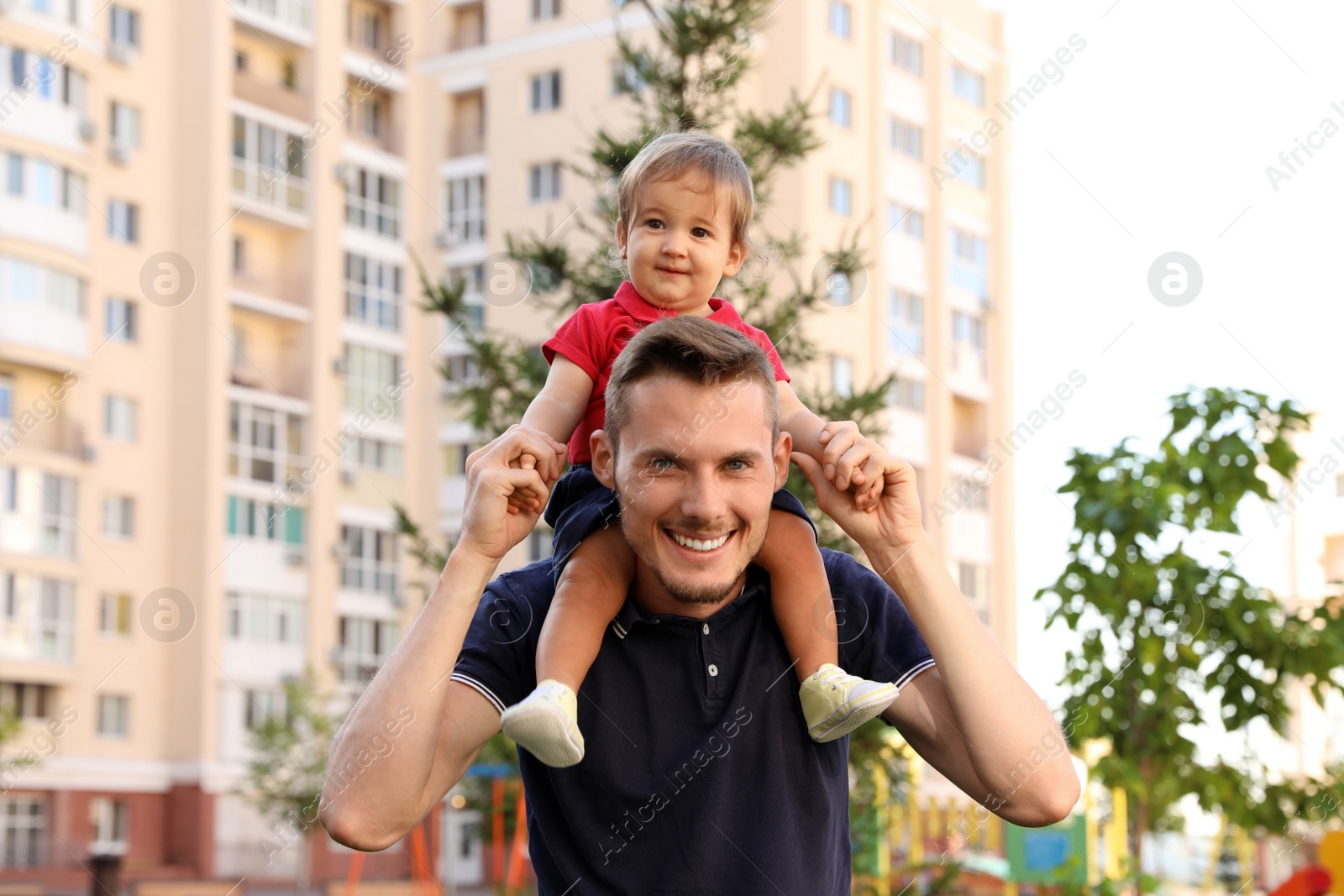 Photo of Father with adorable little baby outdoors. Happy family