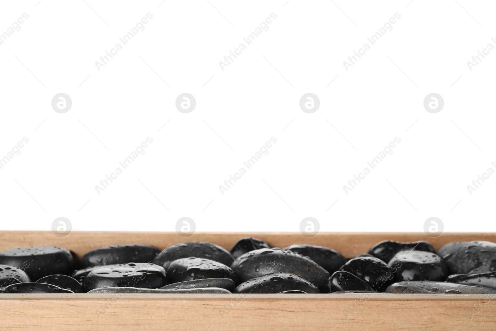 Photo of Wooden tray with wet spa stones against white background