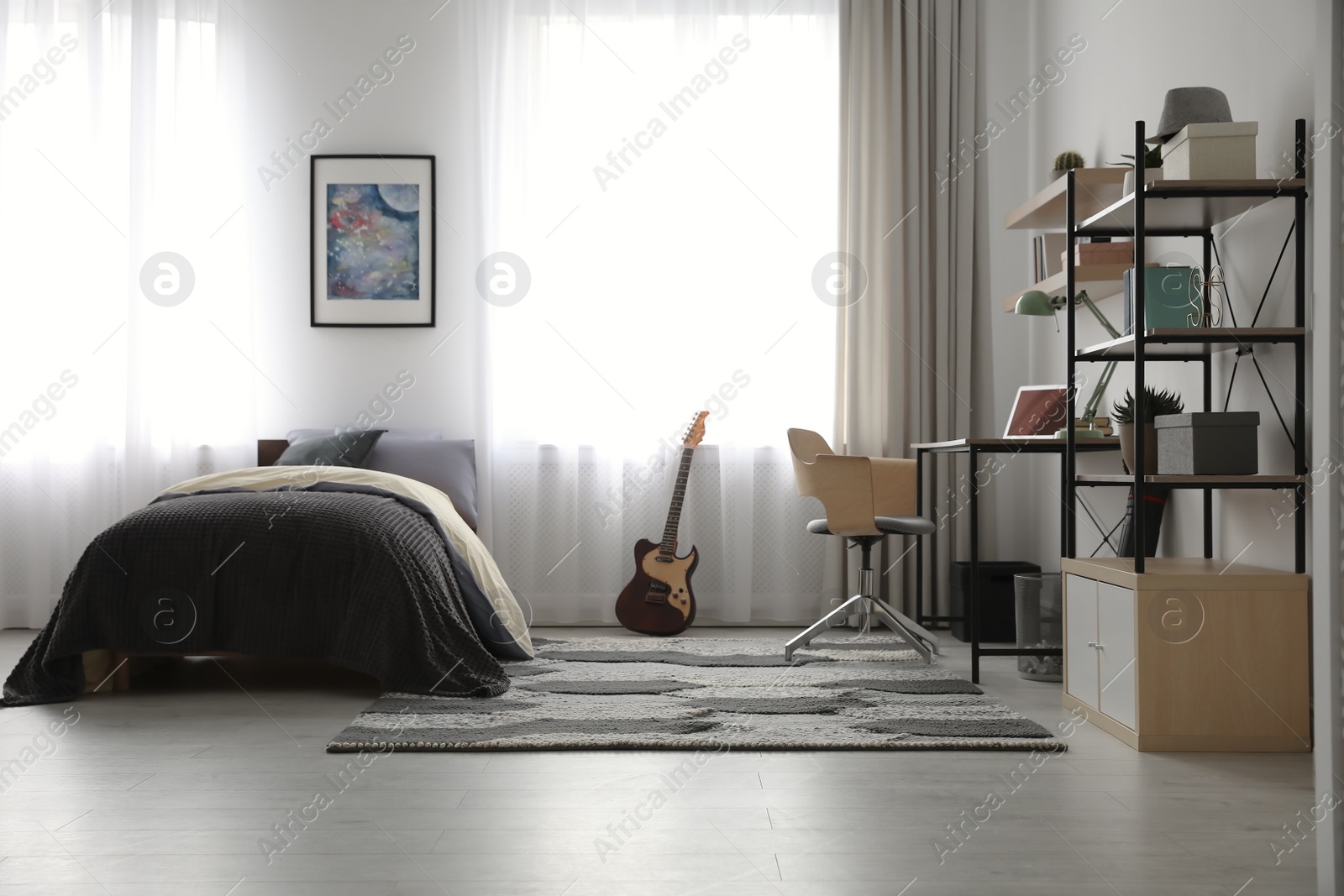 Photo of Modern teenager's room interior with workplace and bed