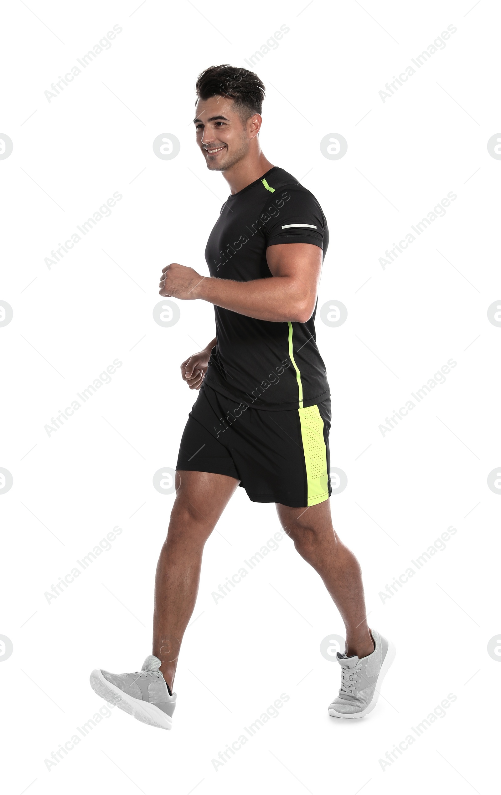 Photo of Sporty young man running on white background