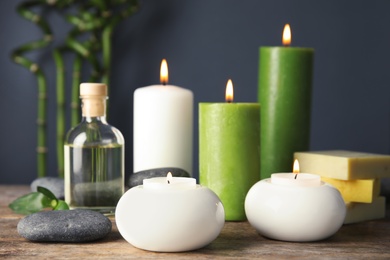 Photo of Spa composition with candles and cosmetic on table