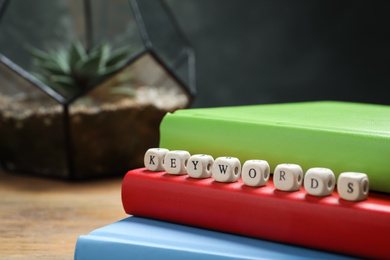 Beads with word KEYWORDS on notebooks, closeup