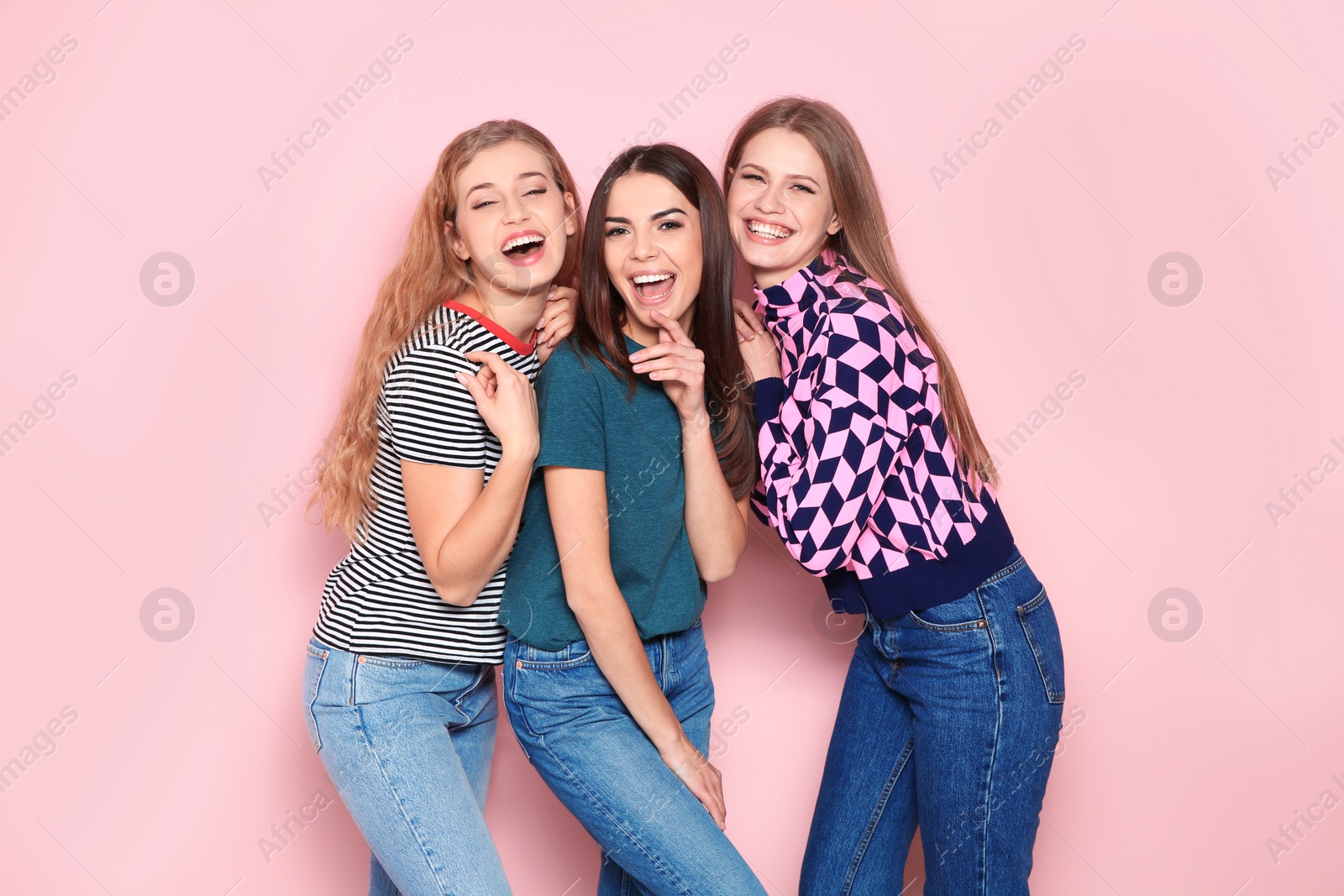 Photo of Portrait of young women laughing on color background