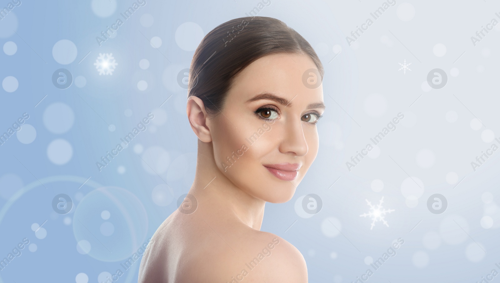 Image of Young woman with perfect smooth skin on light blue background, bokeh effect. Banner design