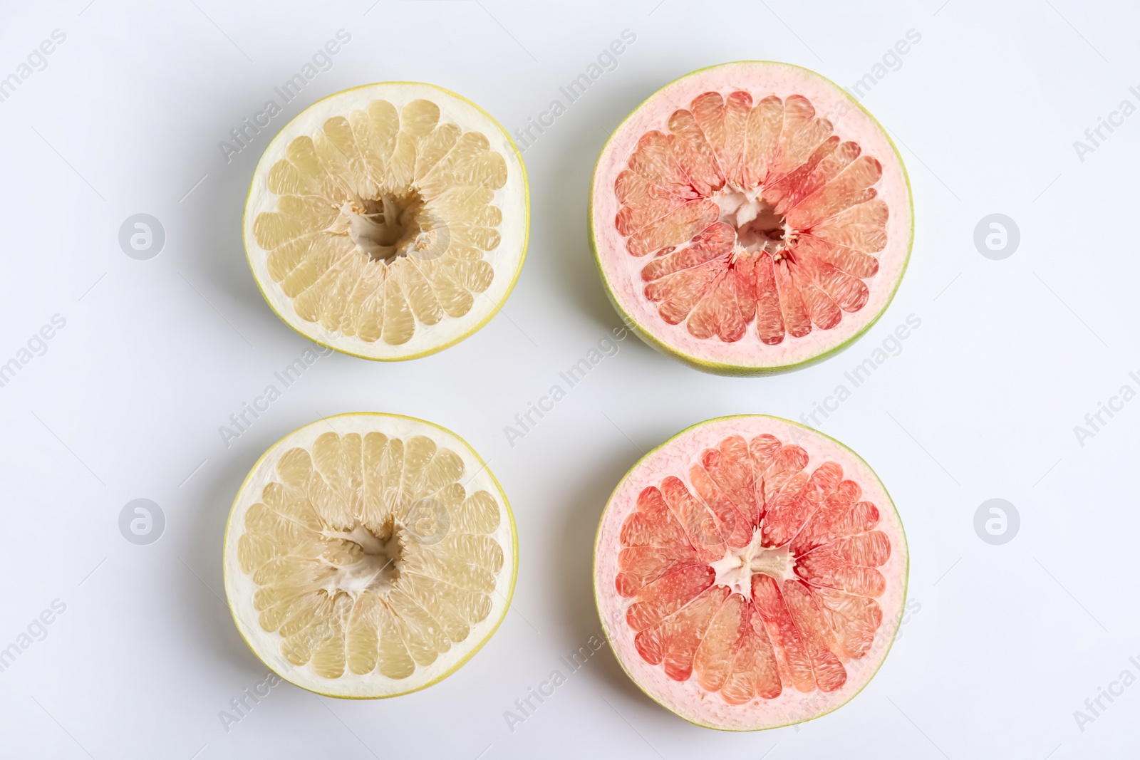 Photo of Fresh cut pomelo fruits on white background, top view