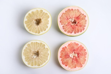 Photo of Fresh cut pomelo fruits on white background, top view