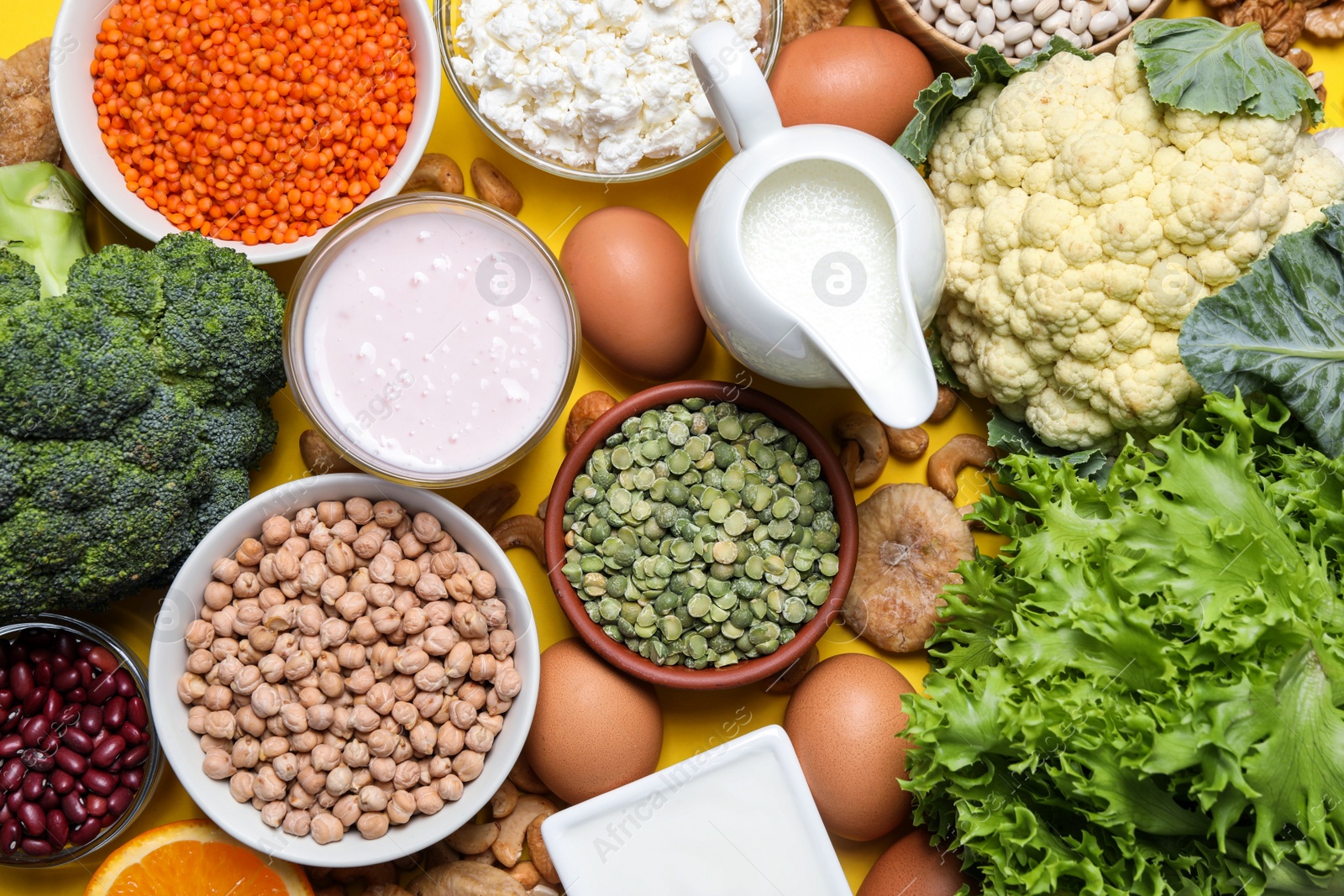 Photo of Food high in calcium. Flat lay composition with different products on yellow background