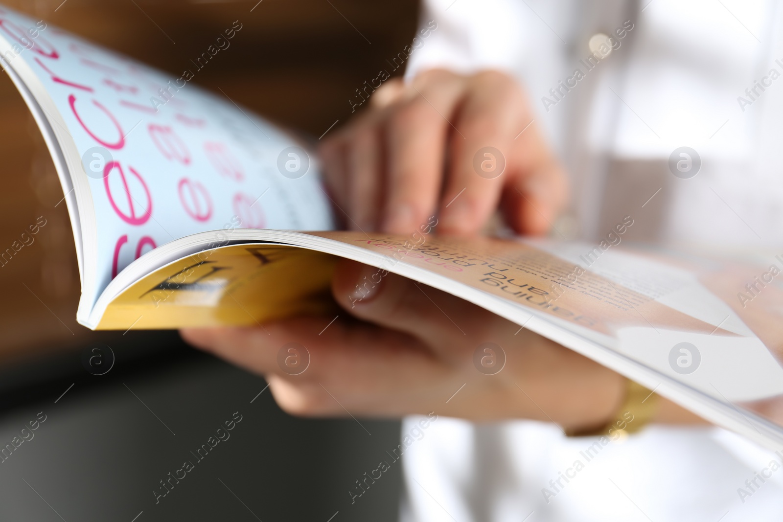 Photo of Woman reading fashion magazine indoors, closeup view