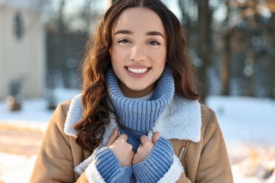 Portrait of smiling woman in winter snowy park