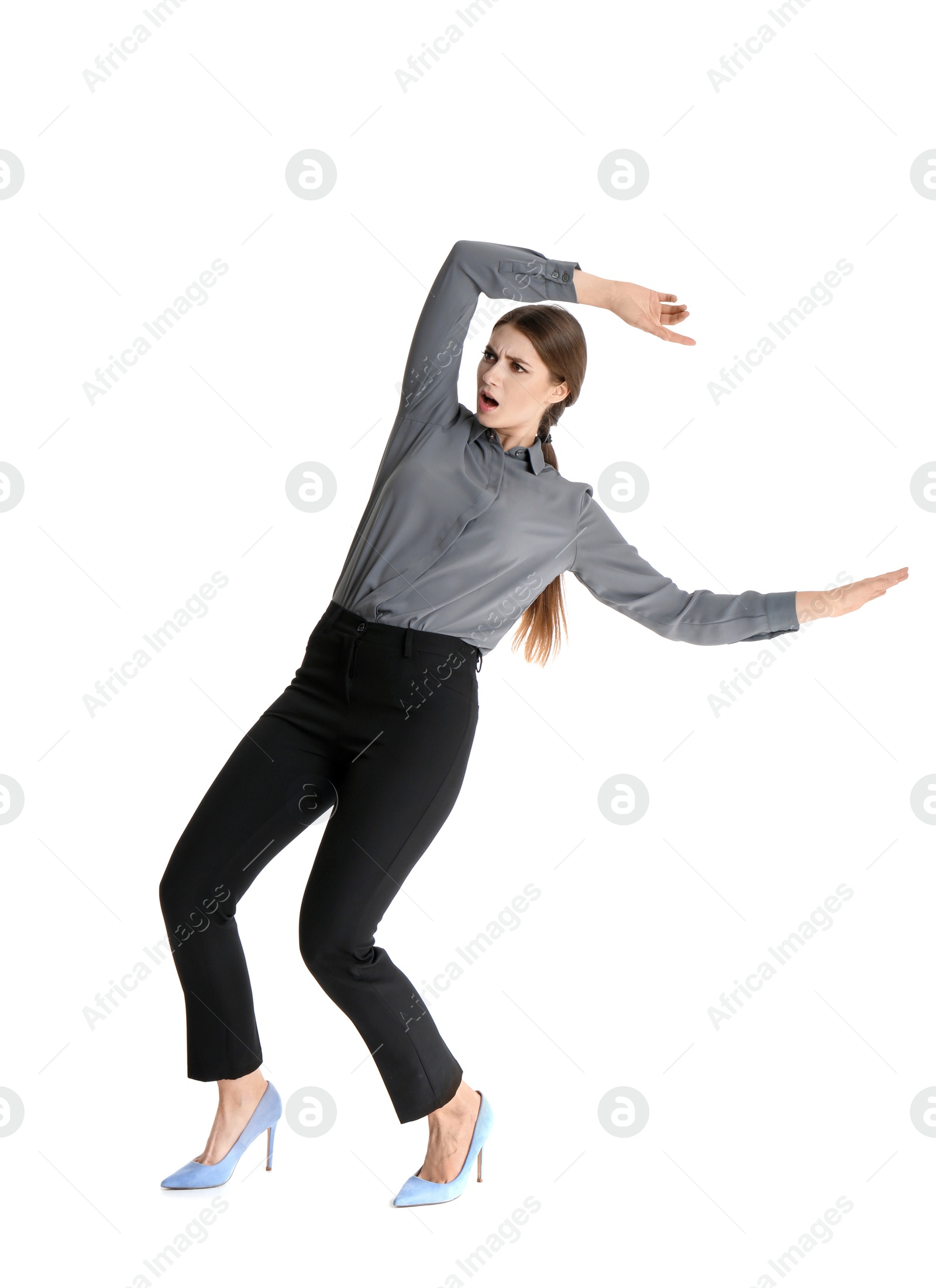 Photo of Young woman attracted to magnet on white background