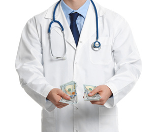 Doctor with bribe on white background, closeup. Corruption in medicine