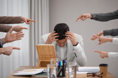 Photo of Coworkers bullying their colleague at workplace in office, closeup