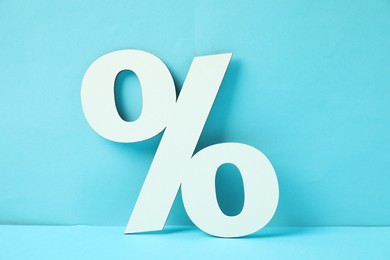 Photo of White percent sign on light blue background