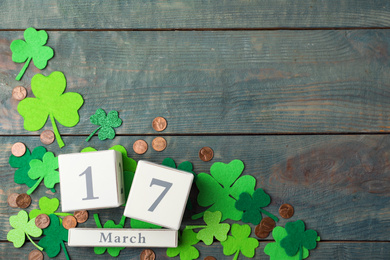 Photo of Flat lay composition with block calendar on blue wooden background, space for text. St. Patrick's Day celebration