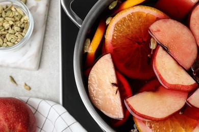 Photo of Delicious hot mulled wine in pot, flat lay