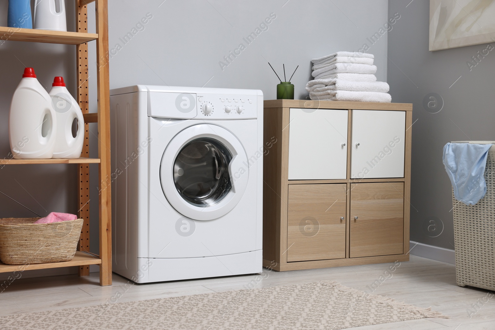 Photo of Laundry room interior with washing machine and furniture