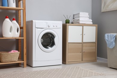 Laundry room interior with washing machine and furniture