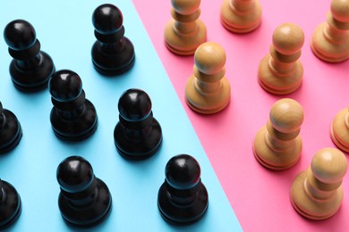Photo of Chess pieces on color background, closeup. Gender equality