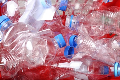 Crate with crumpled plastic bottles, closeup. Trash recycling