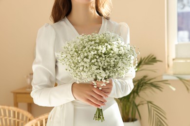 Bride with beautiful bouquet indoors, closeup. Wedding day