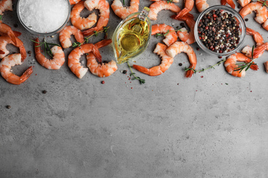 Photo of Flat lay composition with boiled shrimps on grey table. Space for text