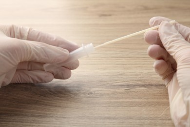 Doctor making laboratory testing at wooden table, closeup