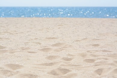 Photo of Sandy beach near sea on sunny day, closeup