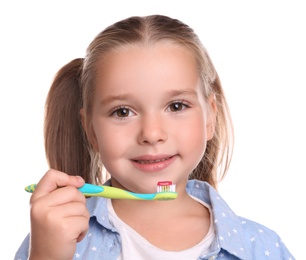 Photo of Little girl holding toothbrush with paste on white background