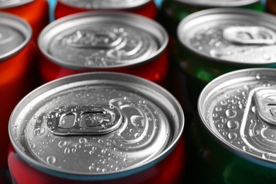 Photo of Energy drinks in wet cans, closeup. Functional beverage
