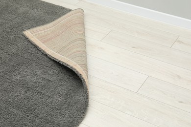 Photo of Soft grey carpet on white laminated floor indoors, space for text