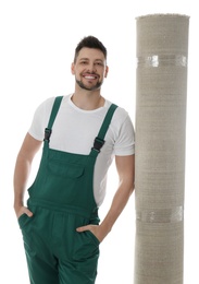 Photo of Male worker with rolled carpet on white background