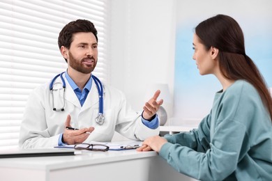 Photo of Doctor consulting patient during appointment in clinic