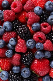 Photo of Different fresh ripe berries as background, top view