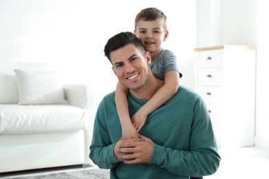 Photo of Dad and son spending time together at home. Happy Father's Day