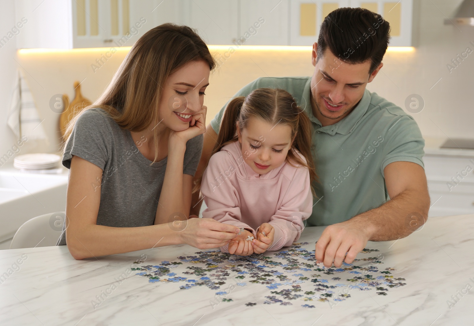 Photo of Happy family playing with puzzles at home