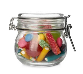 Photo of Many different candies in glass jar isolated on white